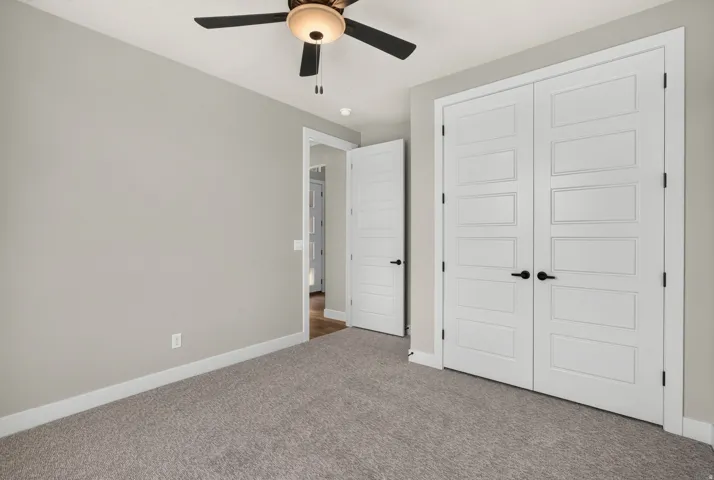 Neutral-toned walls complement the gray carpeting