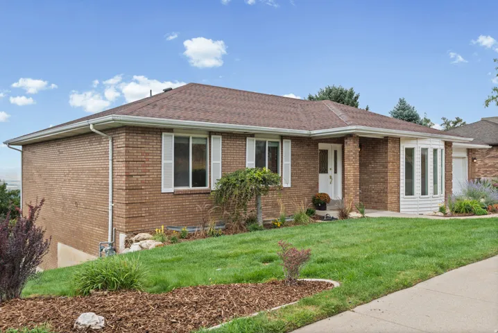 Brick exterior with a brown shingle roof