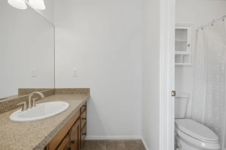 Vanity with a neutral-toned countertop and an undermount sink