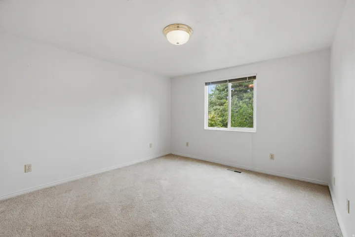Neutral color palette with light-toned carpeting and white walls