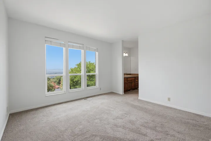 Spacious room with plush carpeting and multiple windows