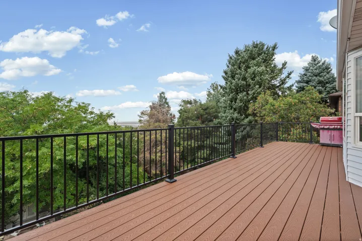 Expansive outdoor deck featuring composite decking and black metal railings