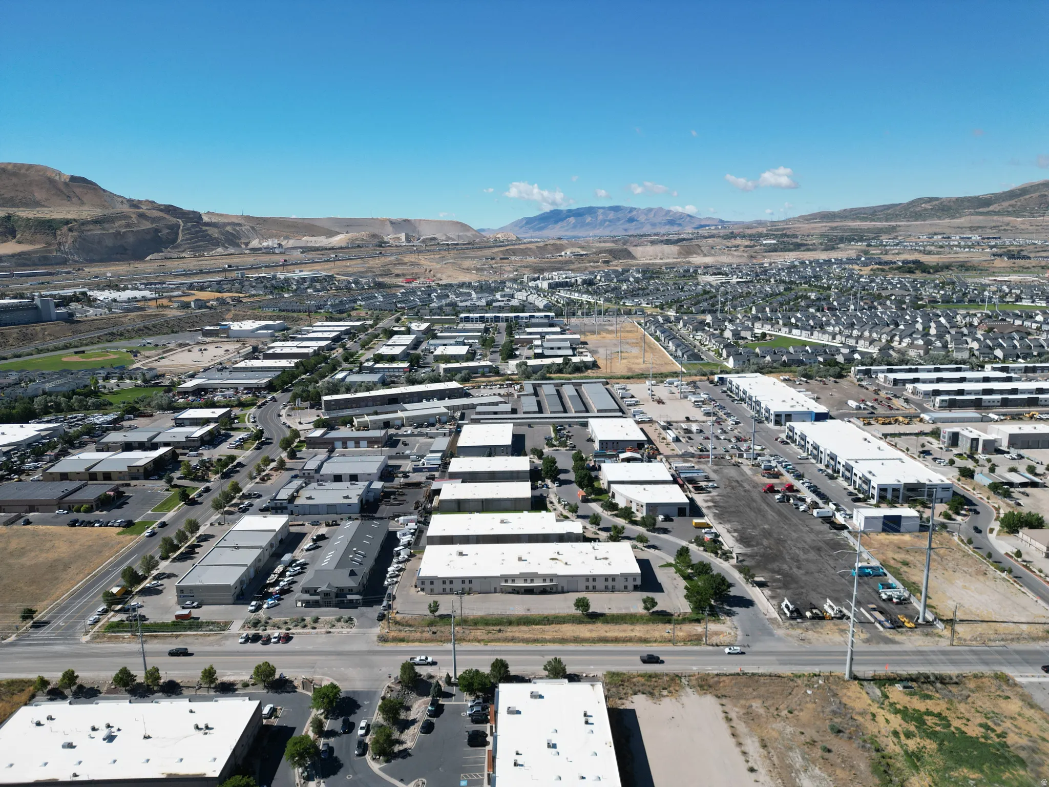 Expansive commercial district with multiple business structures and paved parking areas