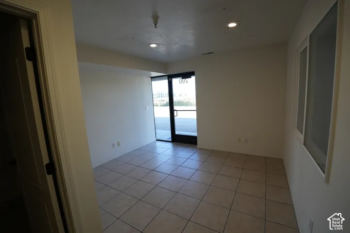Recessed lighting, tile flooring, and large windows with natural light