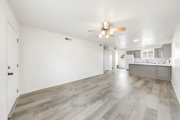 Open-concept living space featuring wood-finish flooring and a ceiling fan
