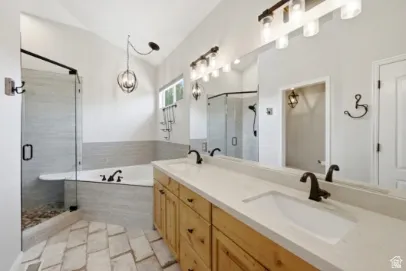 Dual vanity with a white countertop and dark bronze fixtures