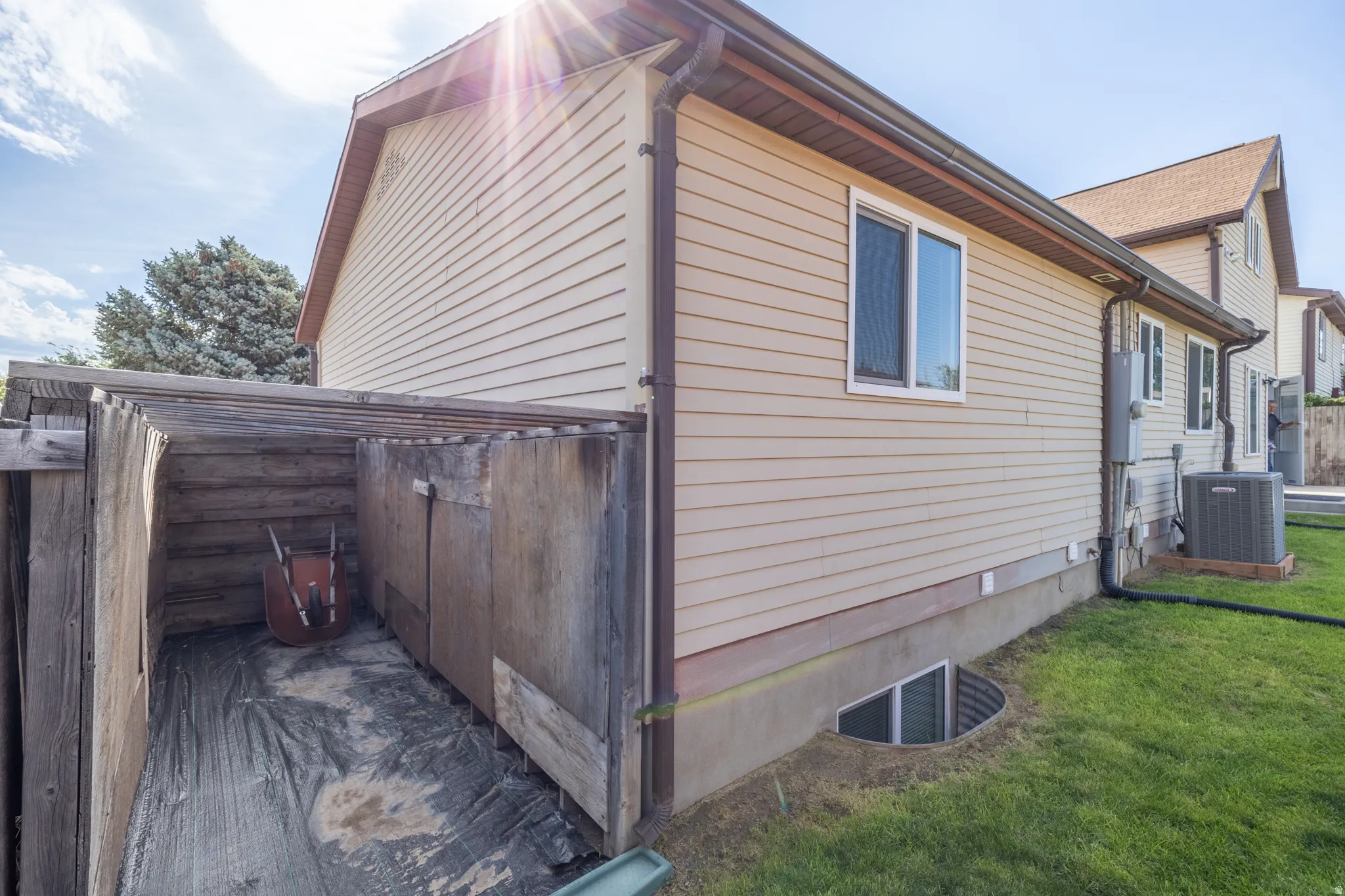 Beige horizontal siding exterior with brown trim and gabled roof