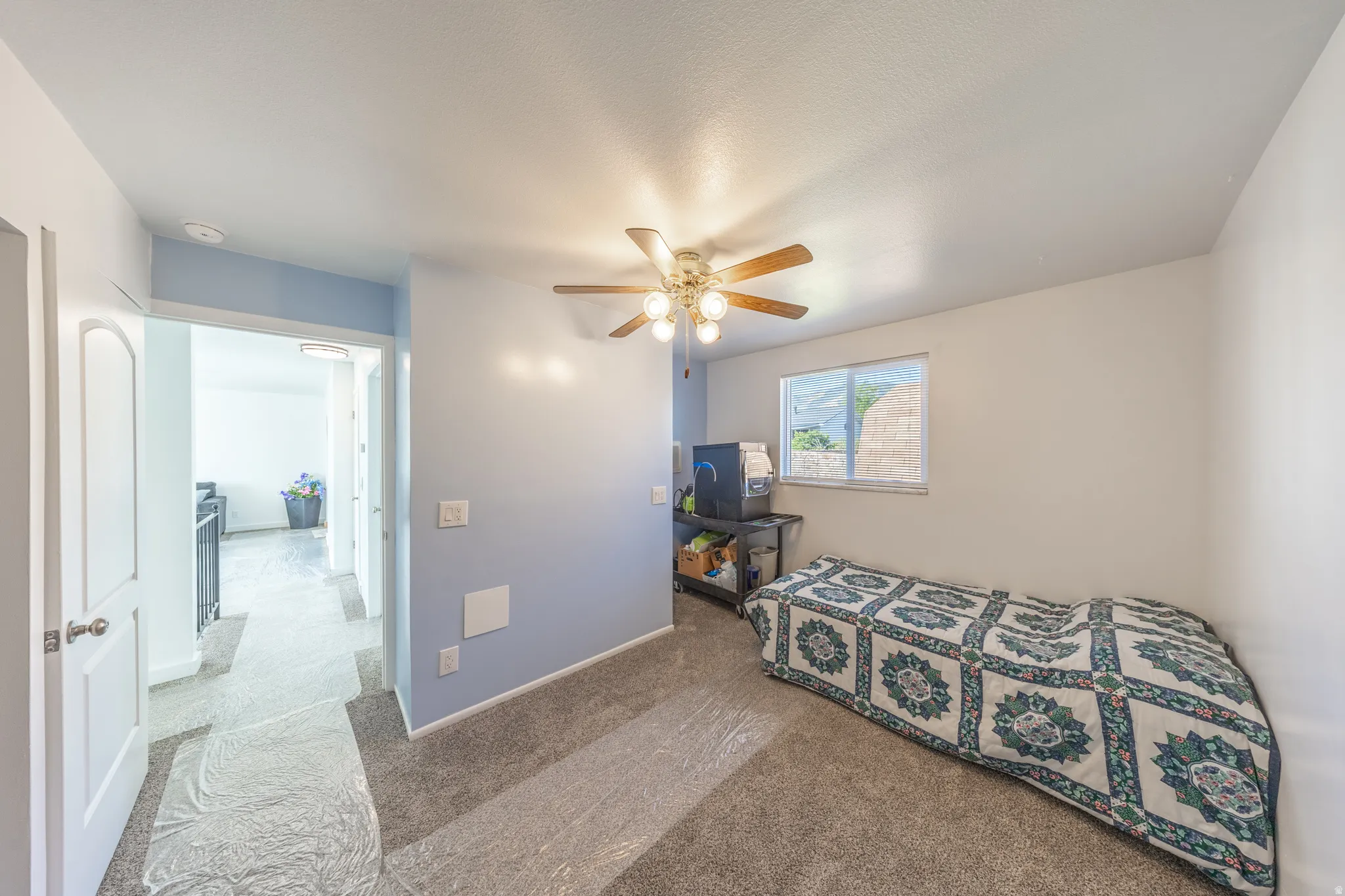 Recessed lighting, ceiling fan with light fixture, window with blinds, light blue wall accent, and gray carpeting