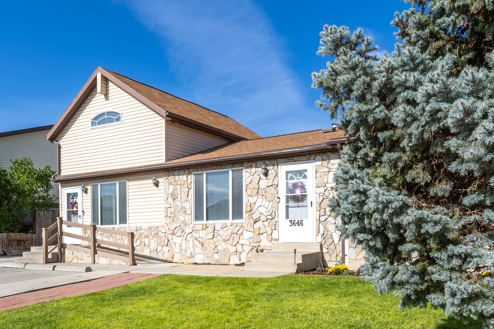 Exterior featuring stone veneer and horizontal siding