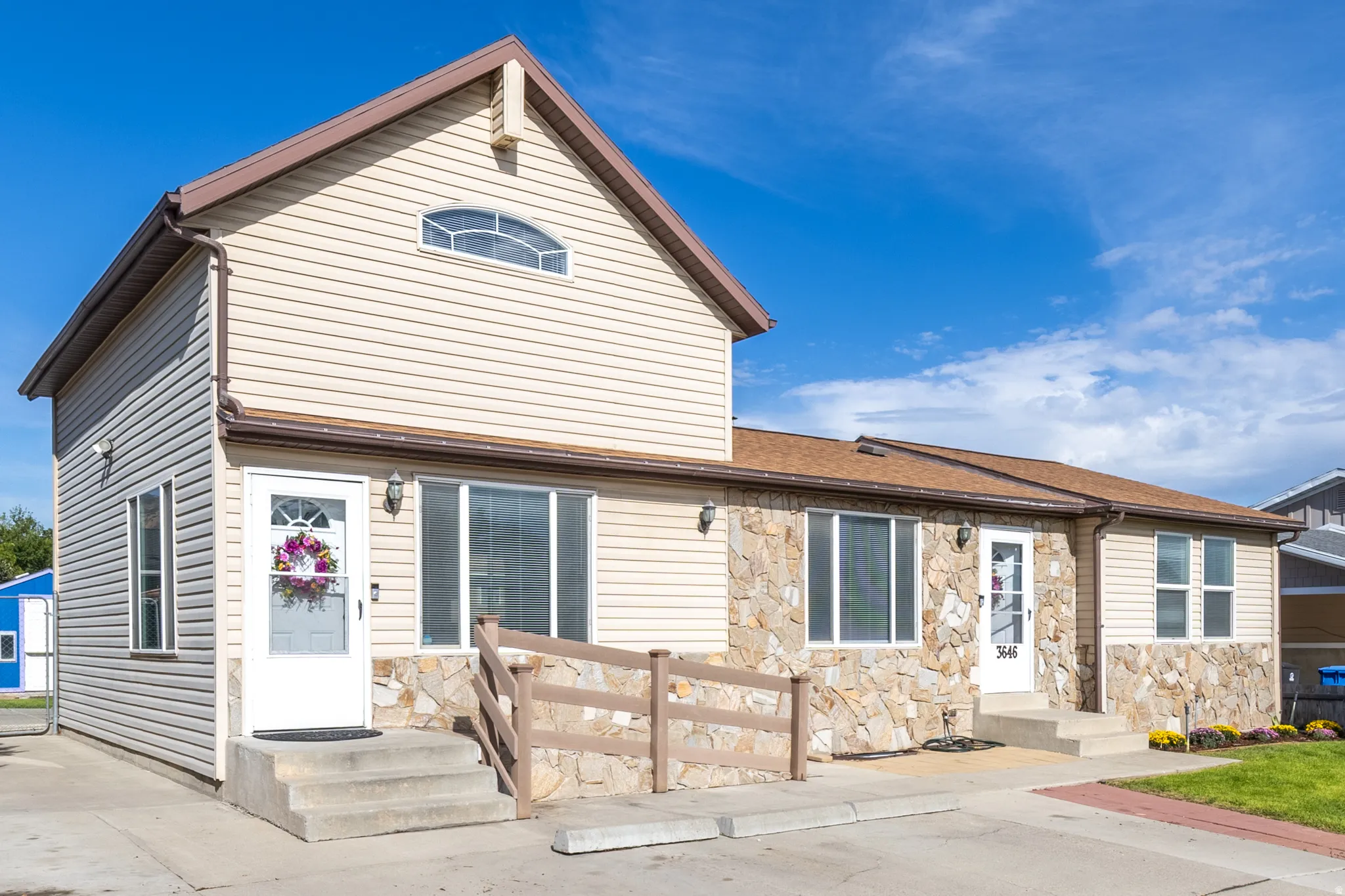 Exterior featuring stone veneer and horizontal siding