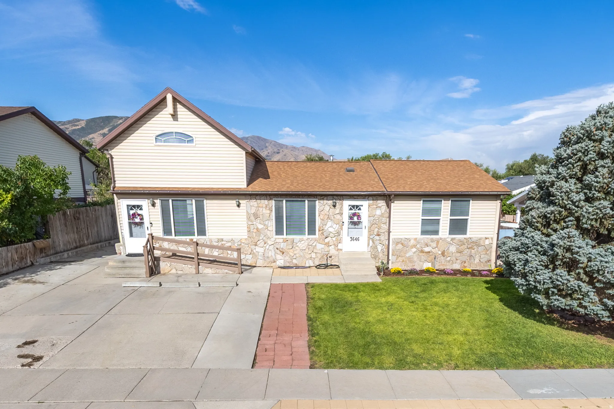 Exterior featuring stone veneer and light-toned siding
