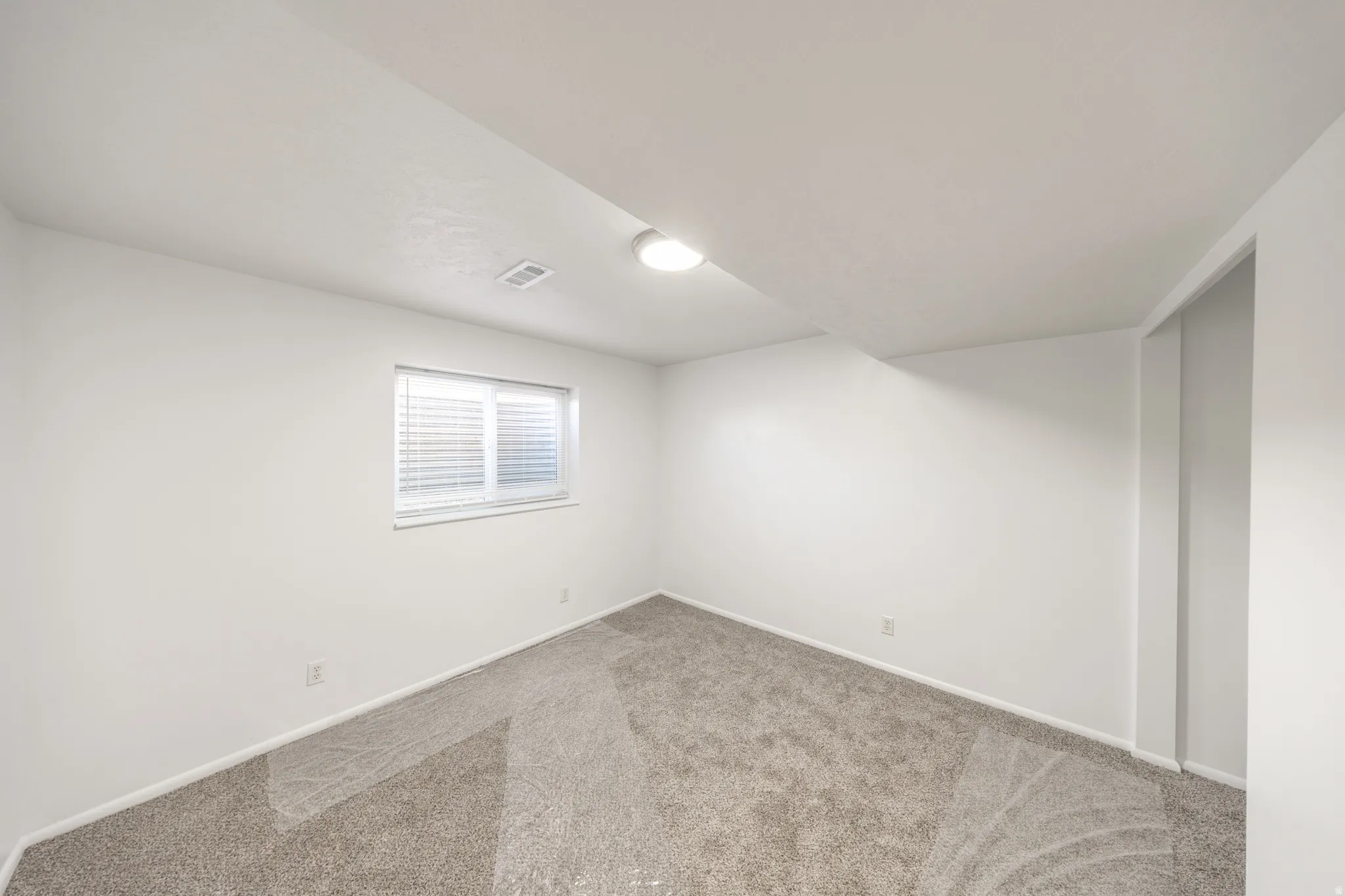 Neutral-toned carpeting with white walls and trim