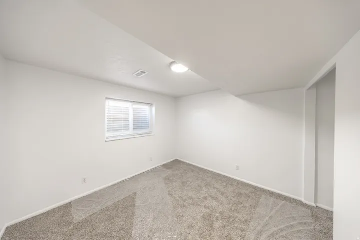 Neutral-toned carpeting with white walls and trim