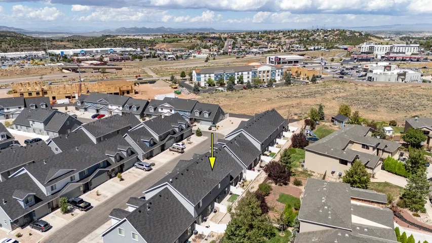 Townhome-style property with a dark gray shingle roof and light gray siding