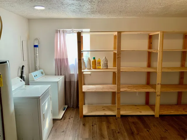 Wood-finish flooring, recessed ceiling lighting, light-filtering window treatments, and extensive built-in wooden shelving