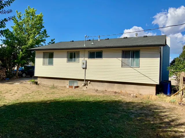 Cream-colored horizontal siding with a dark roof