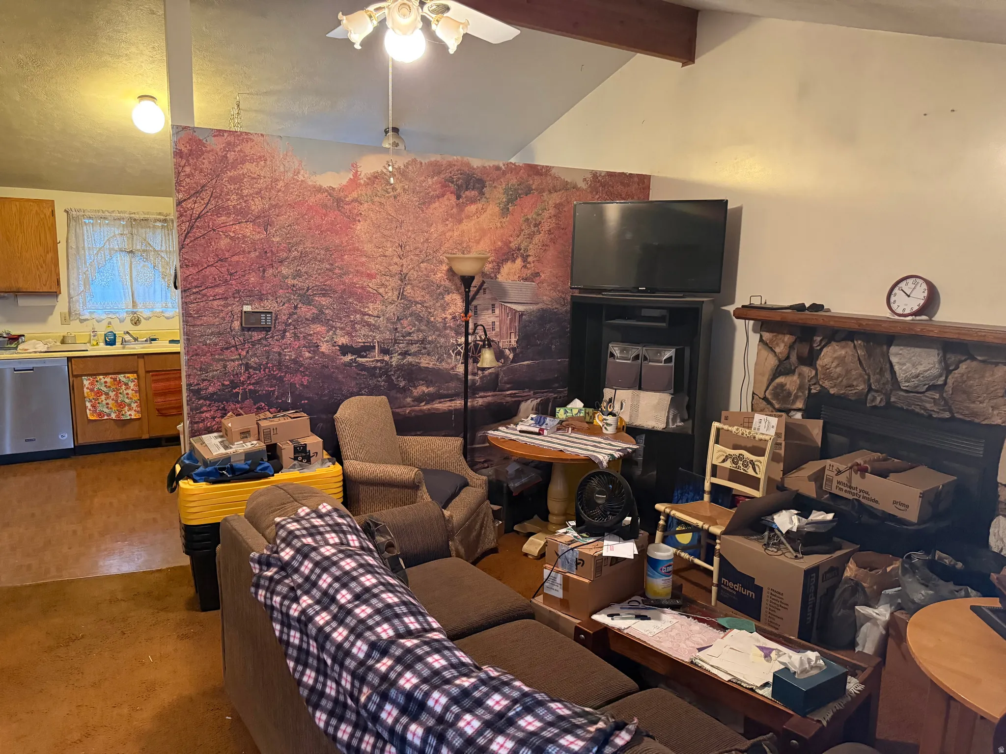 Additional contentThe image shows a residential interior with significant clutter, personal belongings, and furnishings throughout the space