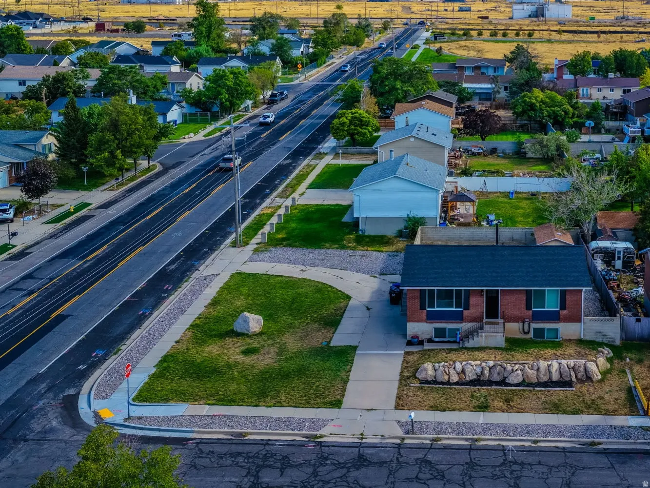 Aerial perspective showcasing residential properties and a paved roadway