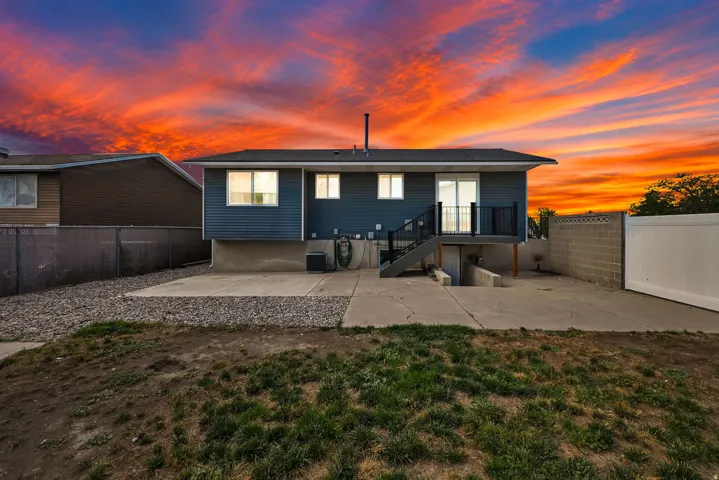 Concrete patio with a privacy fence and block wall