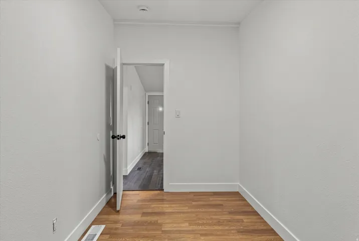 Wood-finish flooring with white trim and a neutral color palette