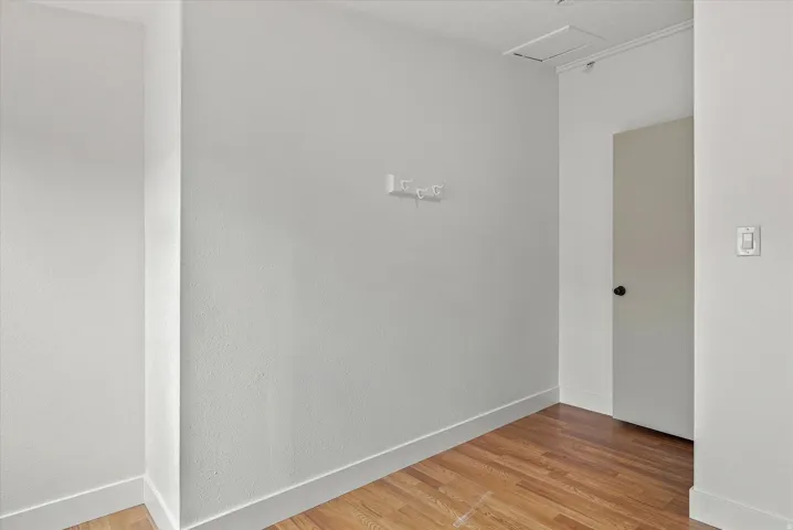 Wood-finish flooring with white baseboards