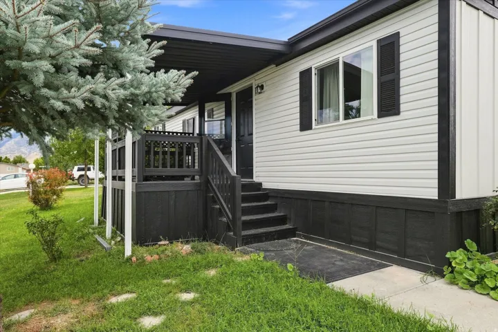 White horizontal siding exterior with dark trim and black shutters
