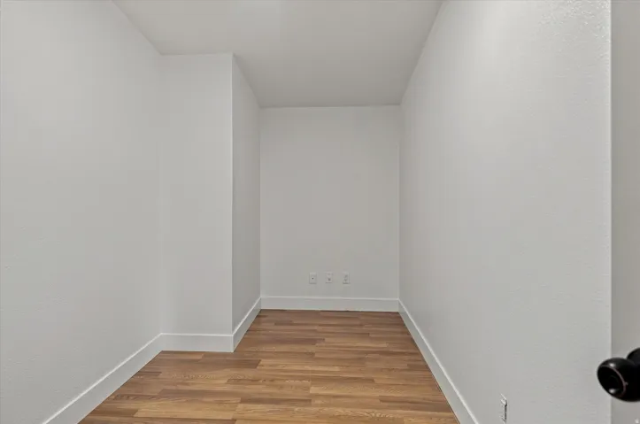 Crisp white walls with wood-finish flooring