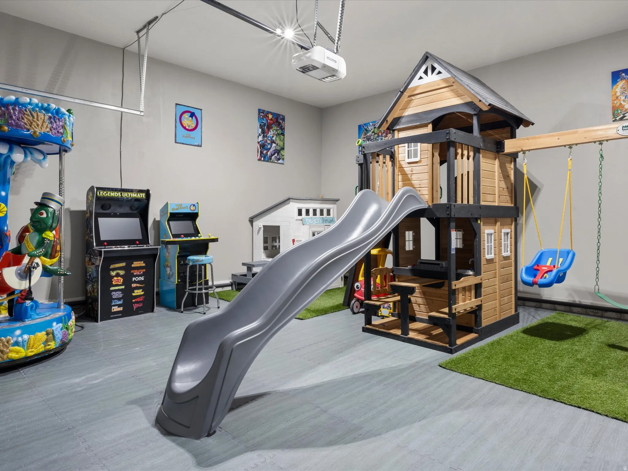 Interior space featuring a play structure with slide, swing set, and a designated artificial turf area