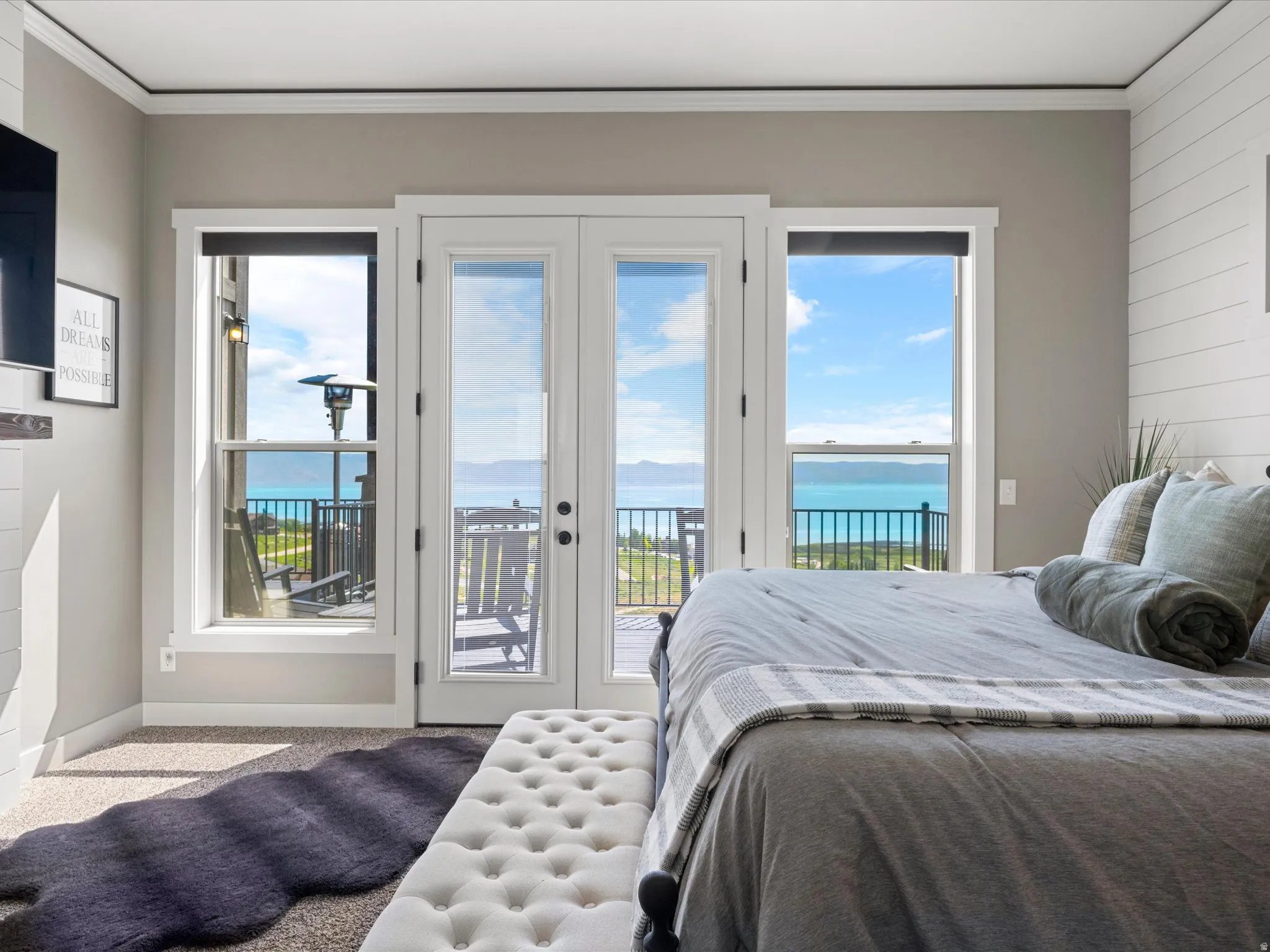 Double French doors opening to an exterior balcony, flanked by two single-hung windows