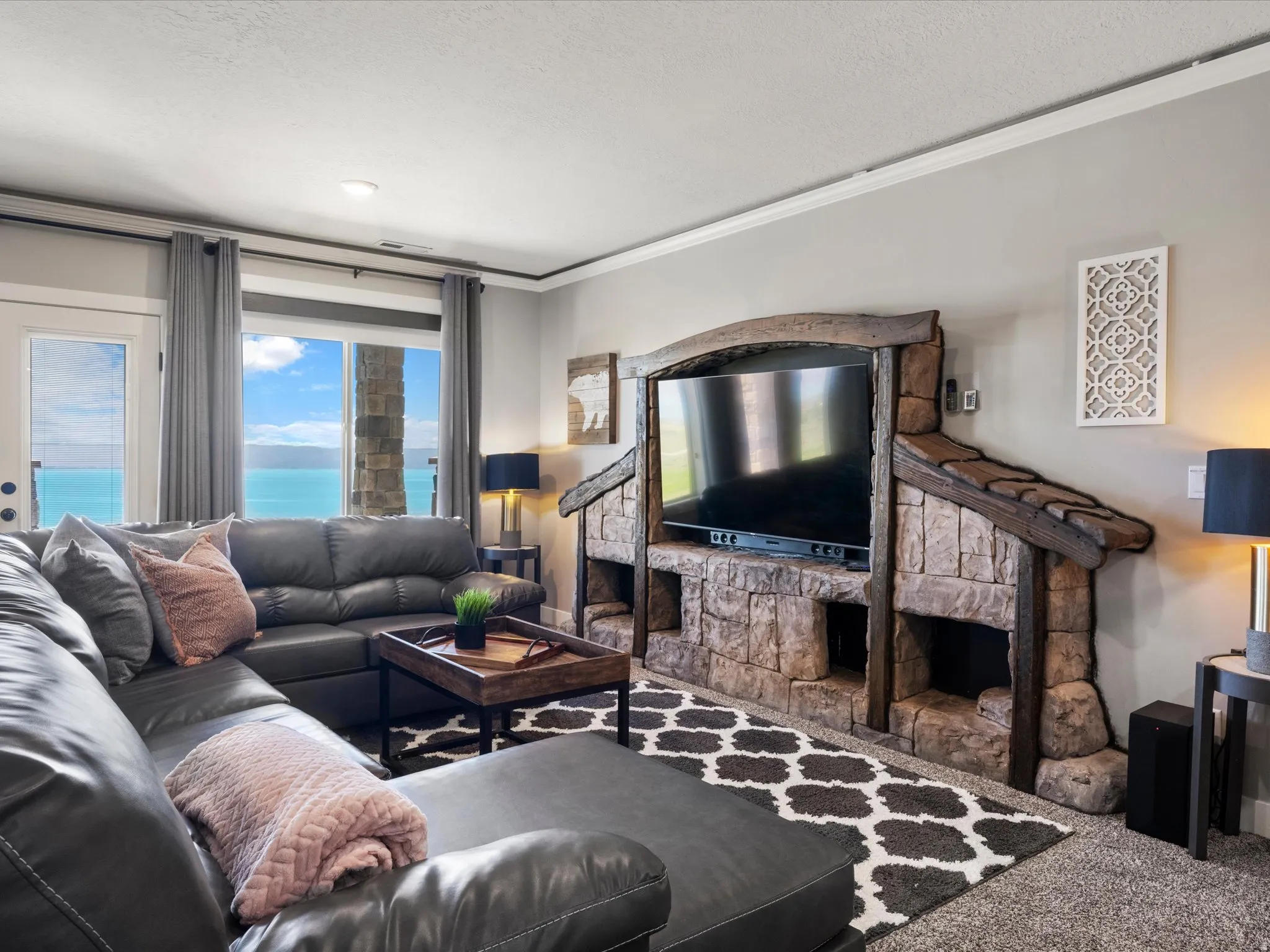 Built-in stone media center with wood accents, large windows, and a glass-paneled door