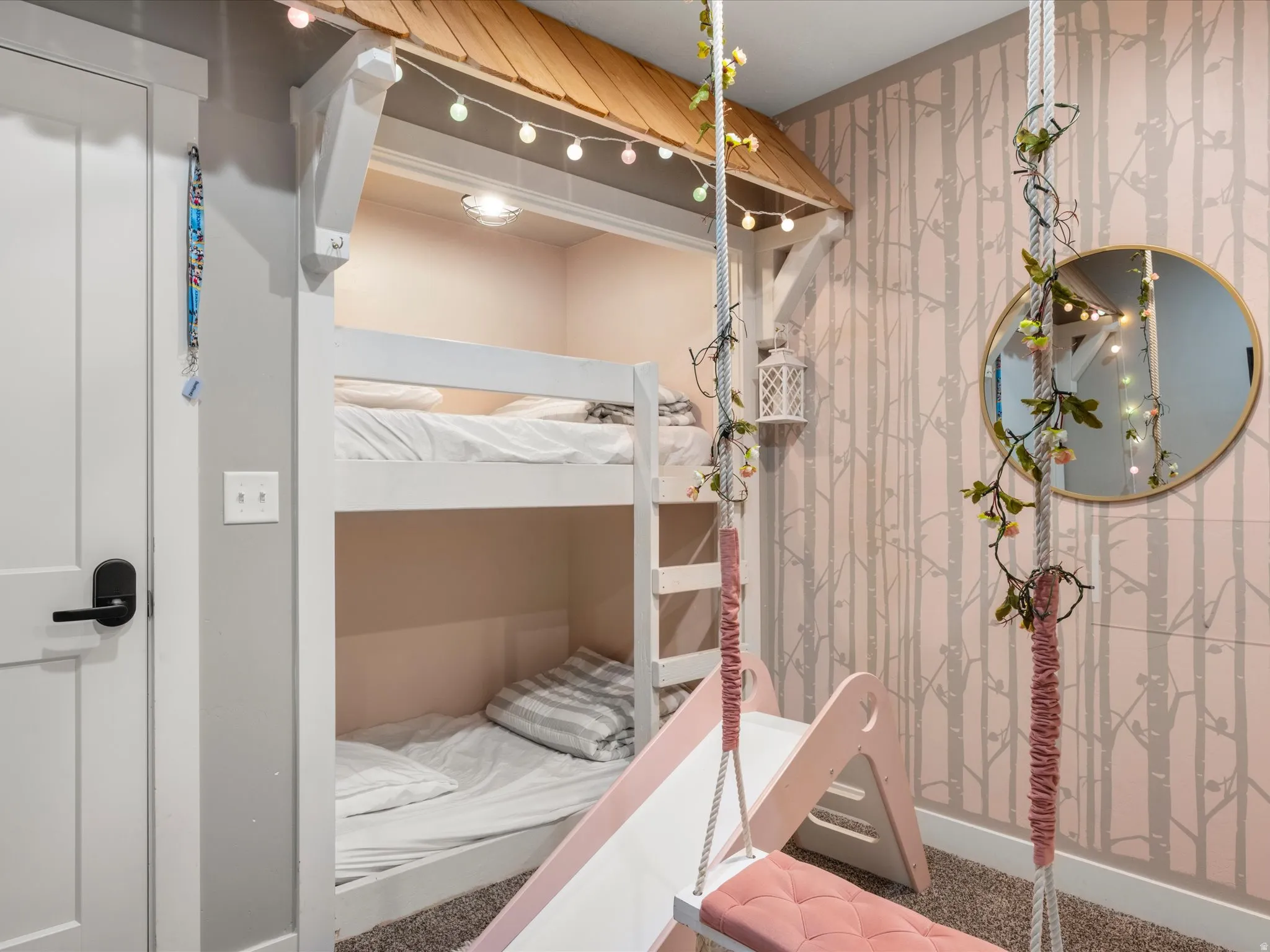 Built-in bunk beds with ladder, integrated lighting, and decorative roofline