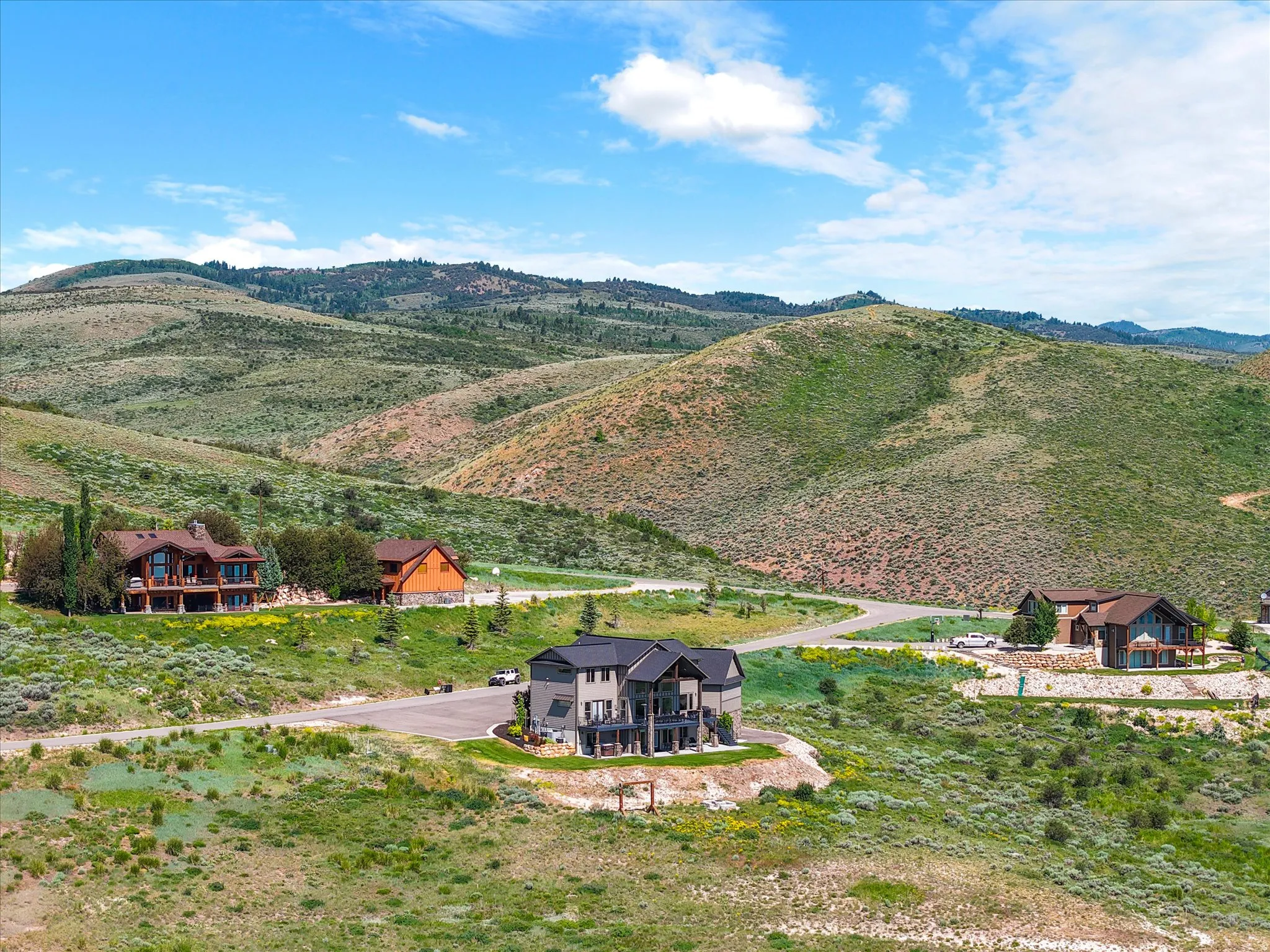 Scenic rural compound featuring multiple residences set against dramatic mountain backdrop