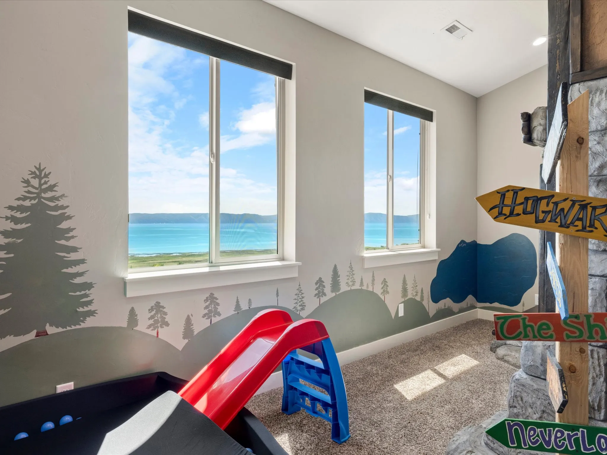 Two tall windows with roller shades