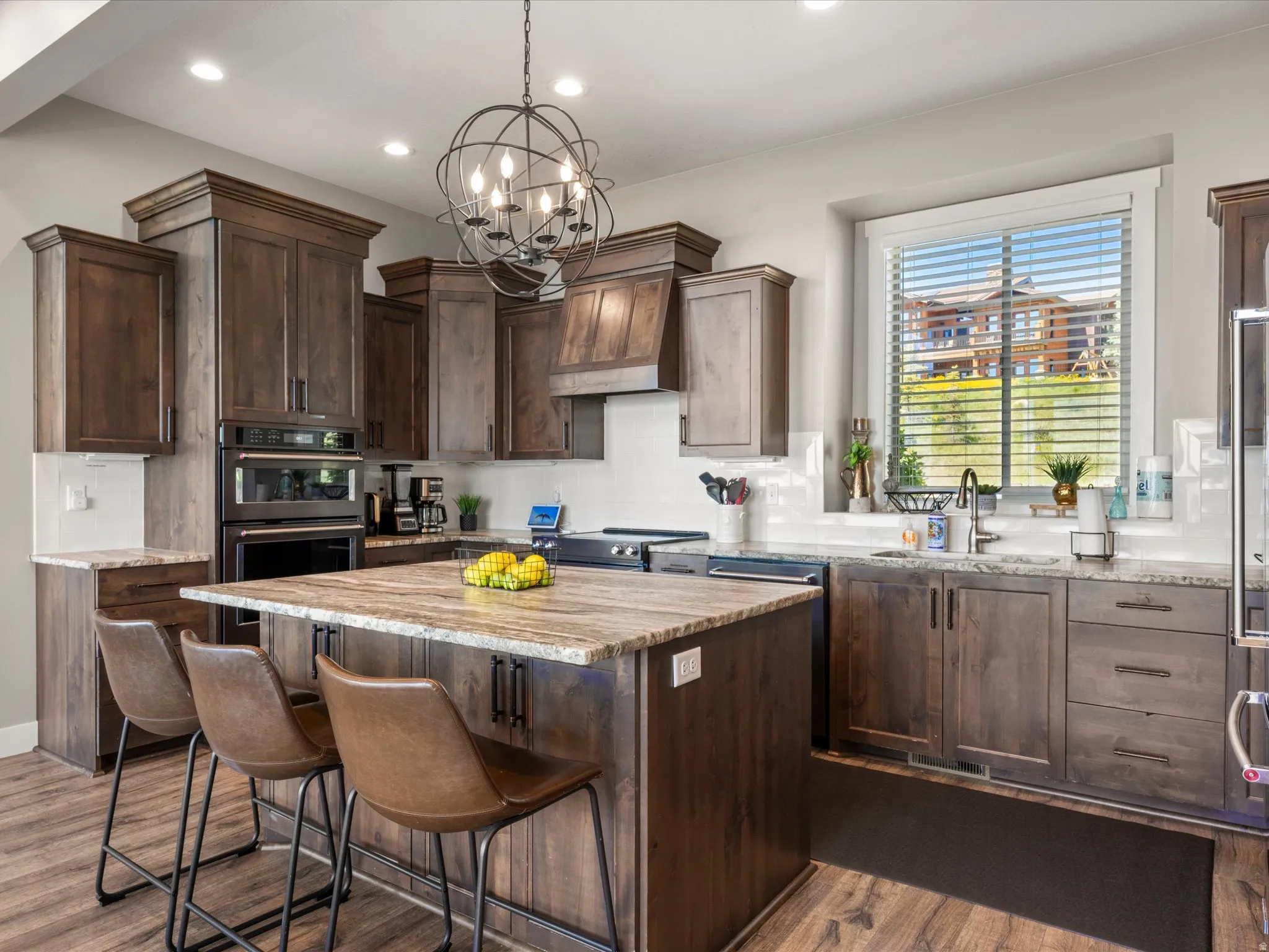 Well-appointed kitchen featuring wood-finish flooring and ample cabinetry