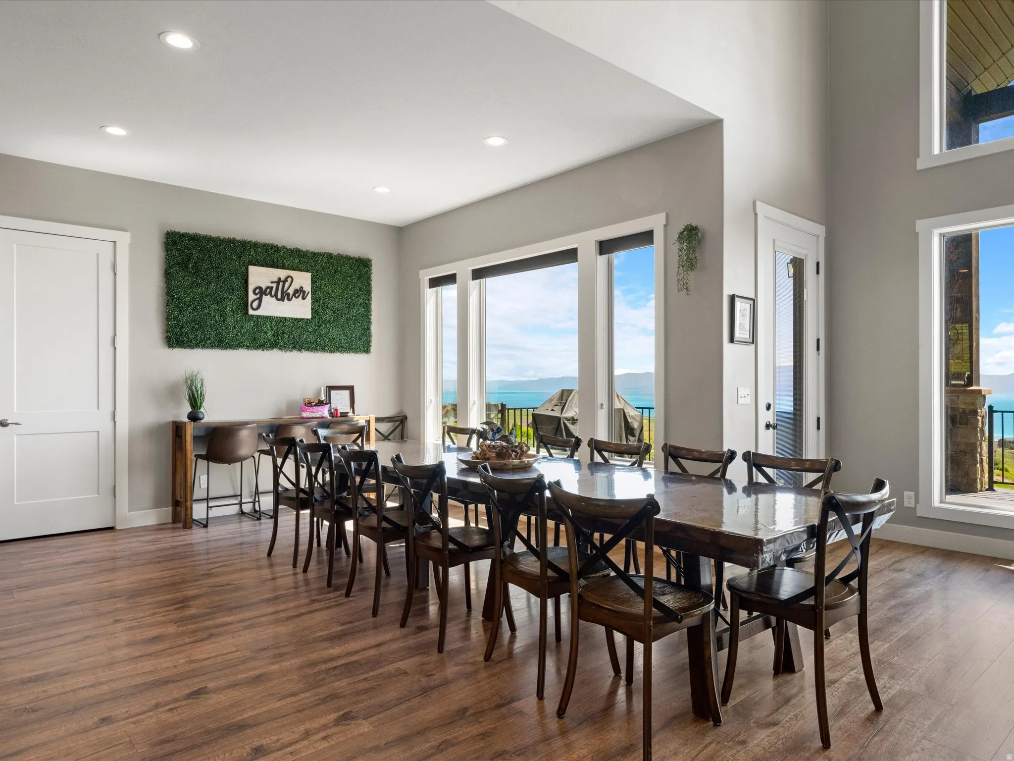 Hardwood-finish flooring, recessed ceiling lighting, large windows, and an outdoor balcony