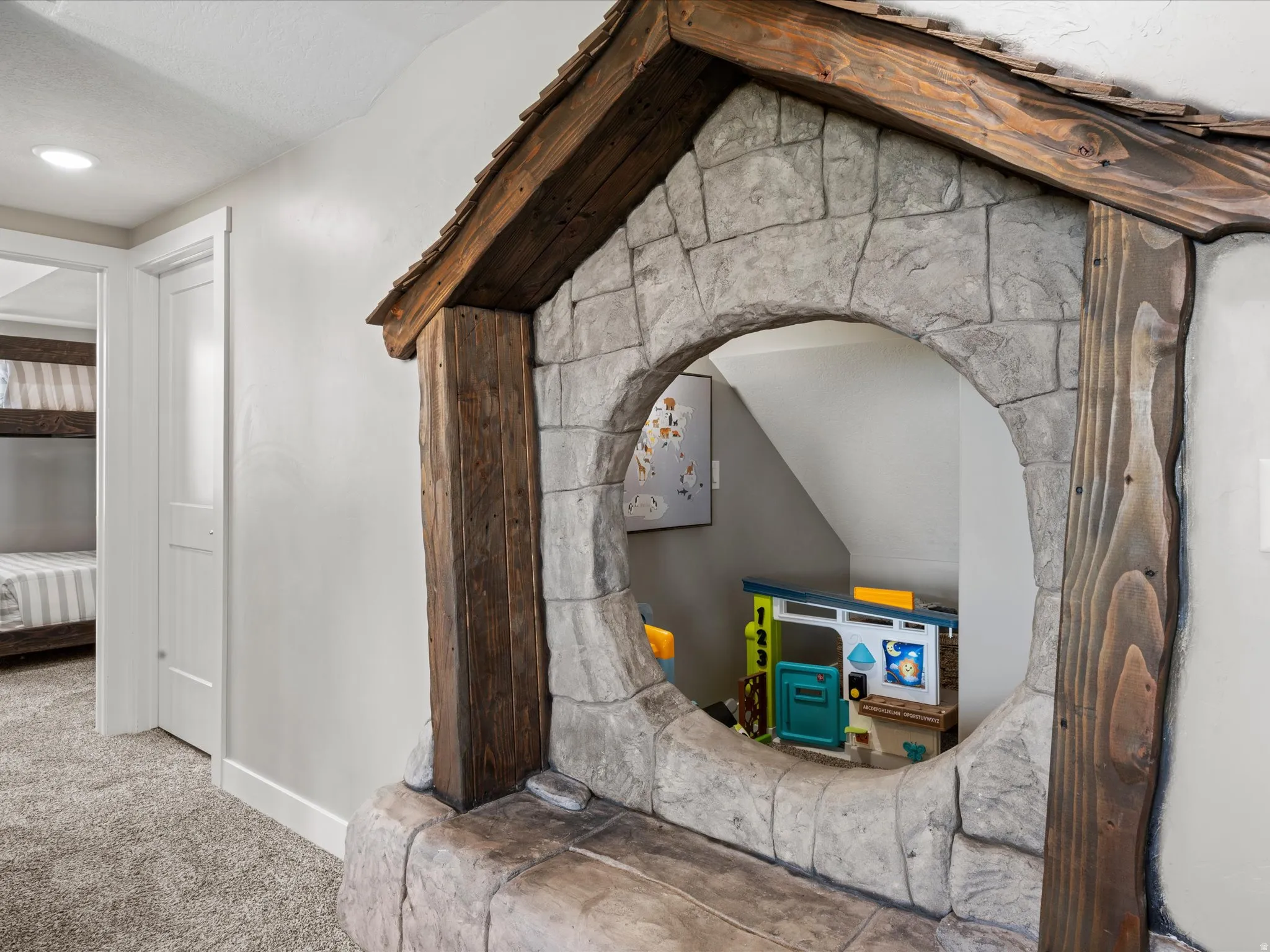 Stone-finish archway with a rounded opening and wood beam accents