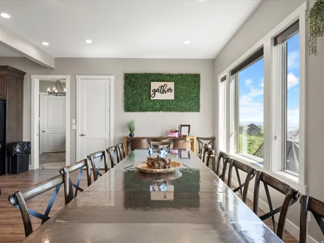 Spacious room featuring multiple large windows, recessed ceiling lighting, light gray walls, and wood-finish flooring