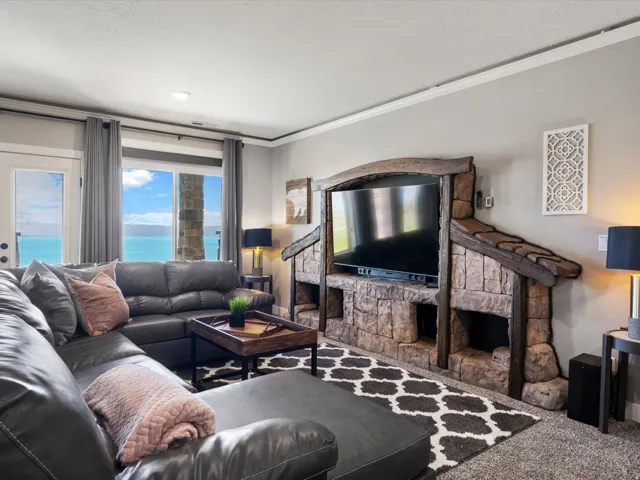 Built-in stone media center with wood accents, large windows, and a glass-paneled door