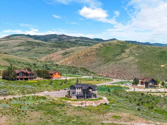 Scenic rural compound featuring multiple residences set against dramatic mountain backdrop