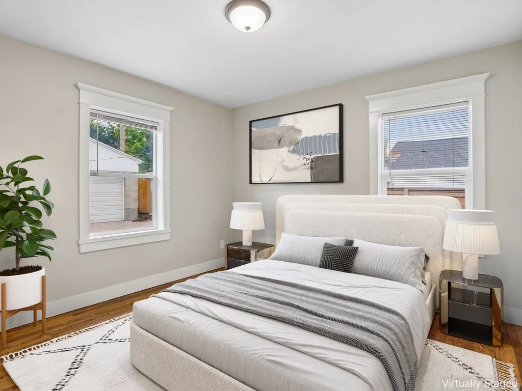 Hardwood flooring, light-toned walls, and recessed lighting