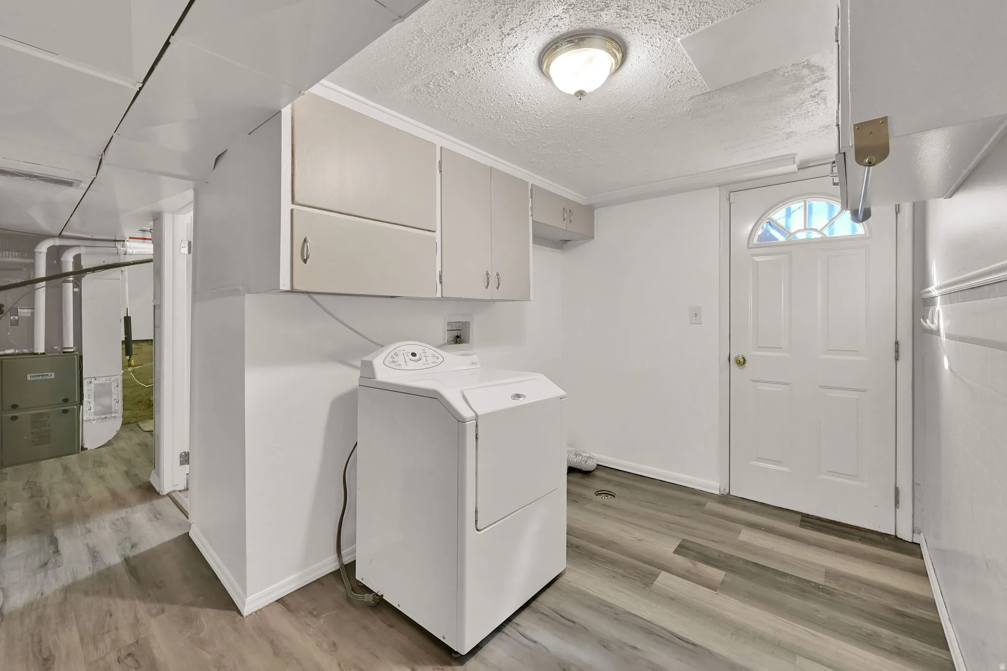 Designated Laundry Area with basement entrance. Dryer is included!