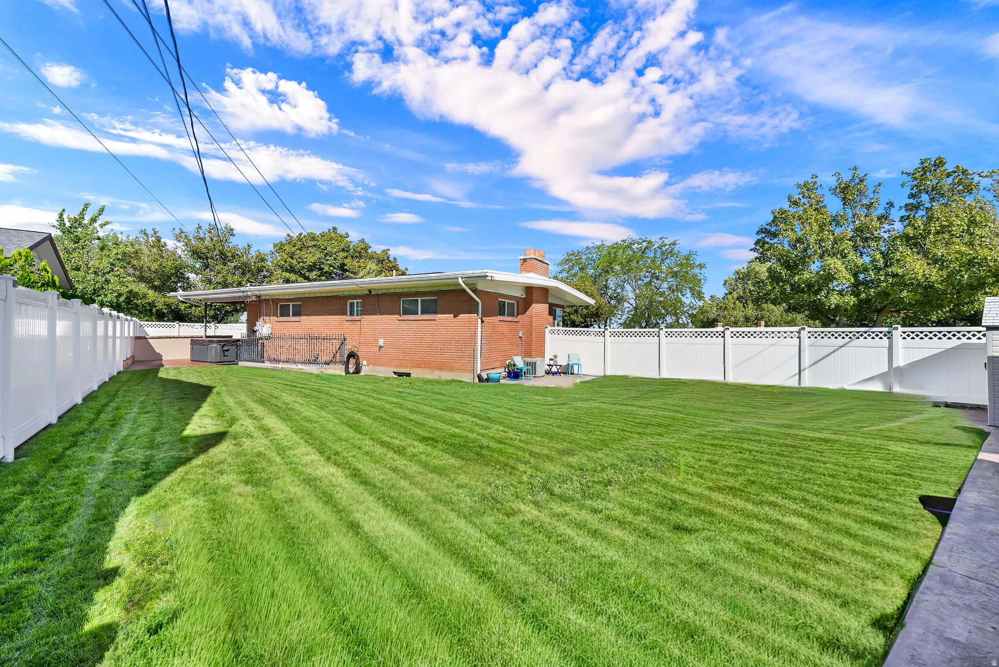 Gather together and hang out in the backyard—there is plenty of grass plus three different concrete patios, including one with a gazebo!