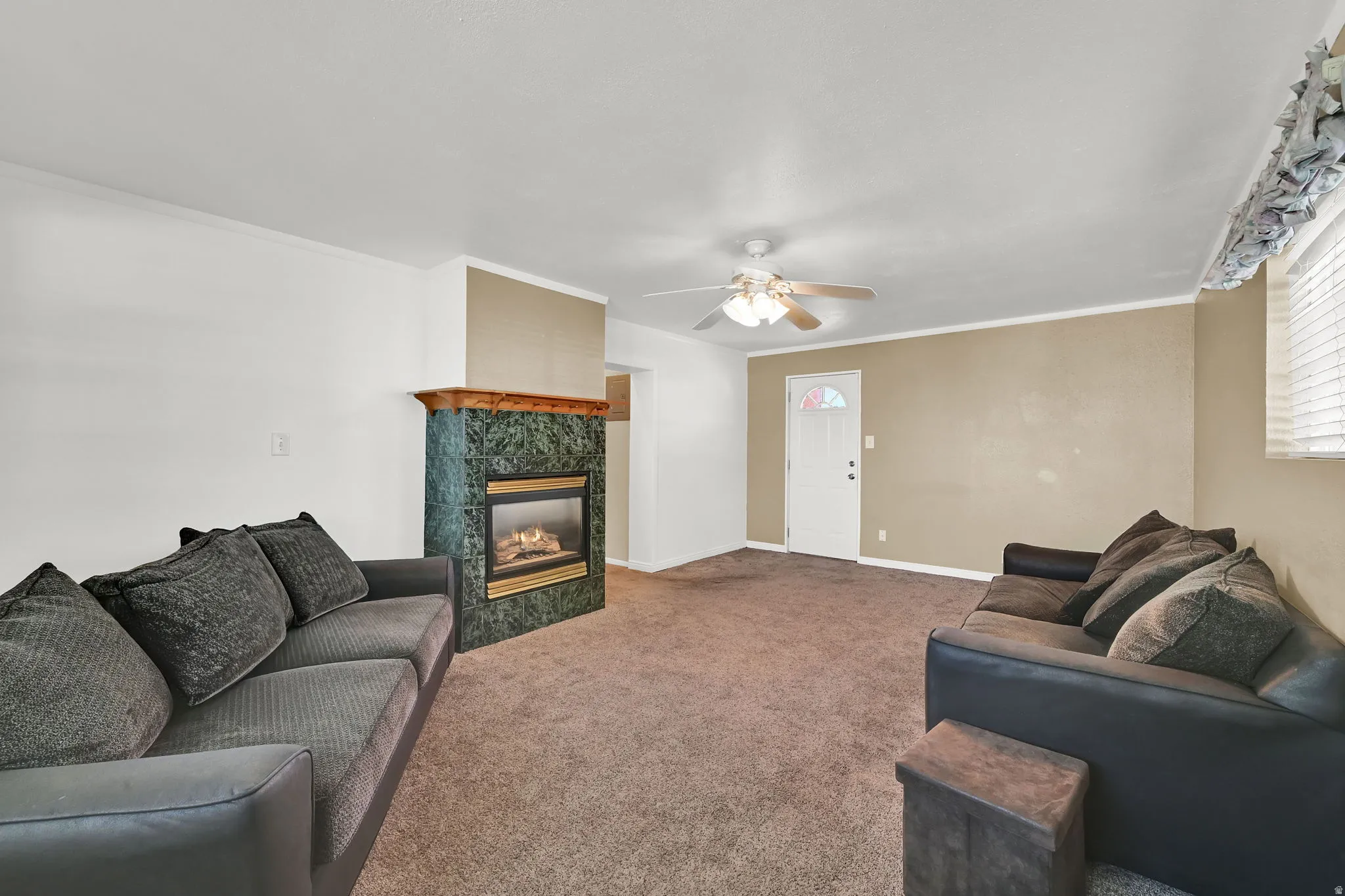 Enjoy twice the living space with a second family room featuring neutral paint and carpet, a cozy gas fireplace, and direct backyard access to a covered patio.
