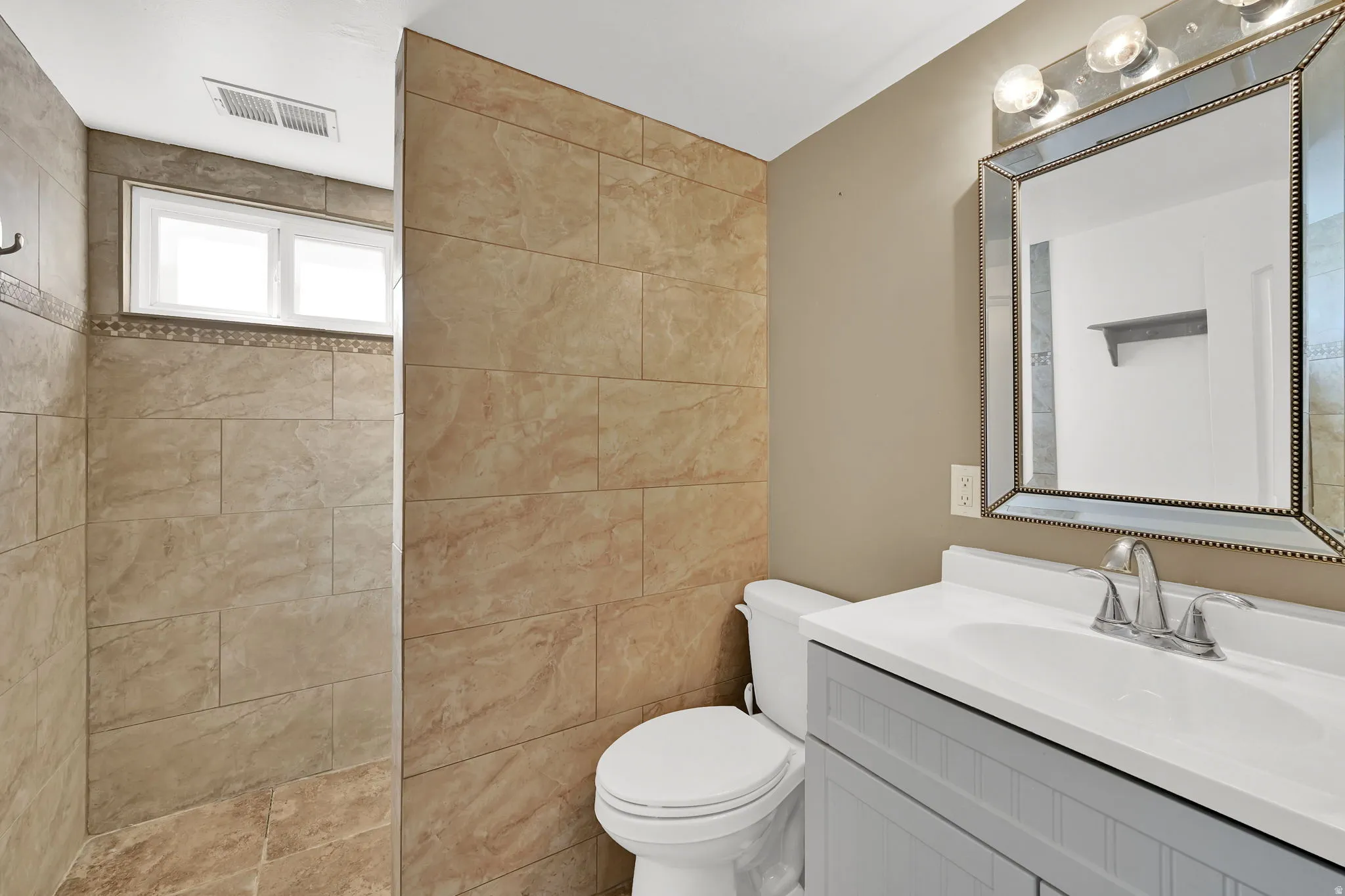 Remodeled bath with tile flooring, walk in shower, new vanity, sink, plumbing and fixtures