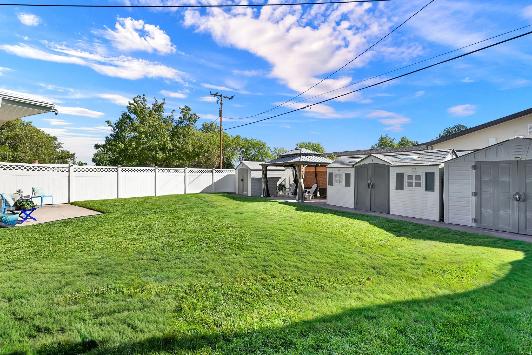 Gazebo and three storage sheds included