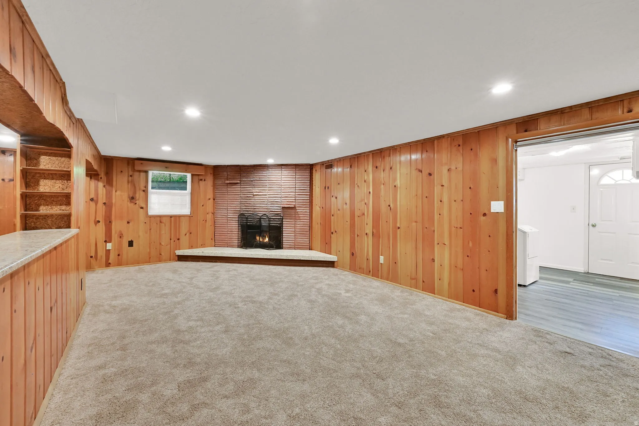 And then there were three! A one-of-a-kind third family room serves as the ultimate hangout space, featuring updated carpeting with thick padding, a fireplace, and a convenient dry bar.