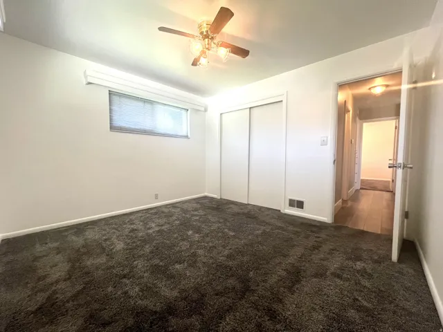 A second peek of the primary bedroom looking toward the closet and entry door