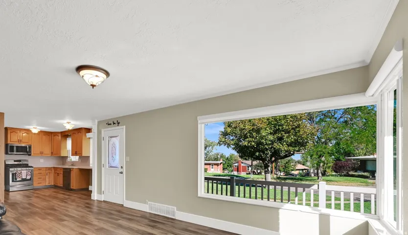 At the heart of the home sits a welcoming living area where picture windows fill the space with light, making it the perfect backdrop for loved ones to gather