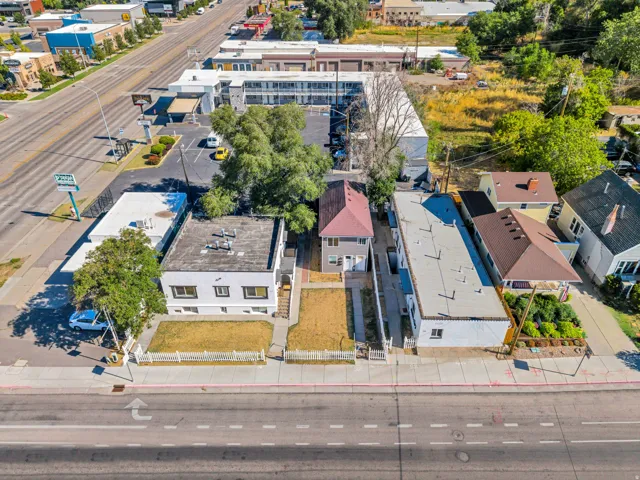 Aerial view showcasing a mixed-use property with multiple residential structures featuring varied architectural styles, including modern and traditional designs