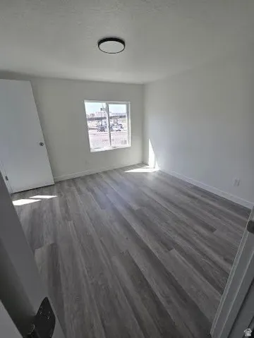 Neutral white walls with wood-finish flooring